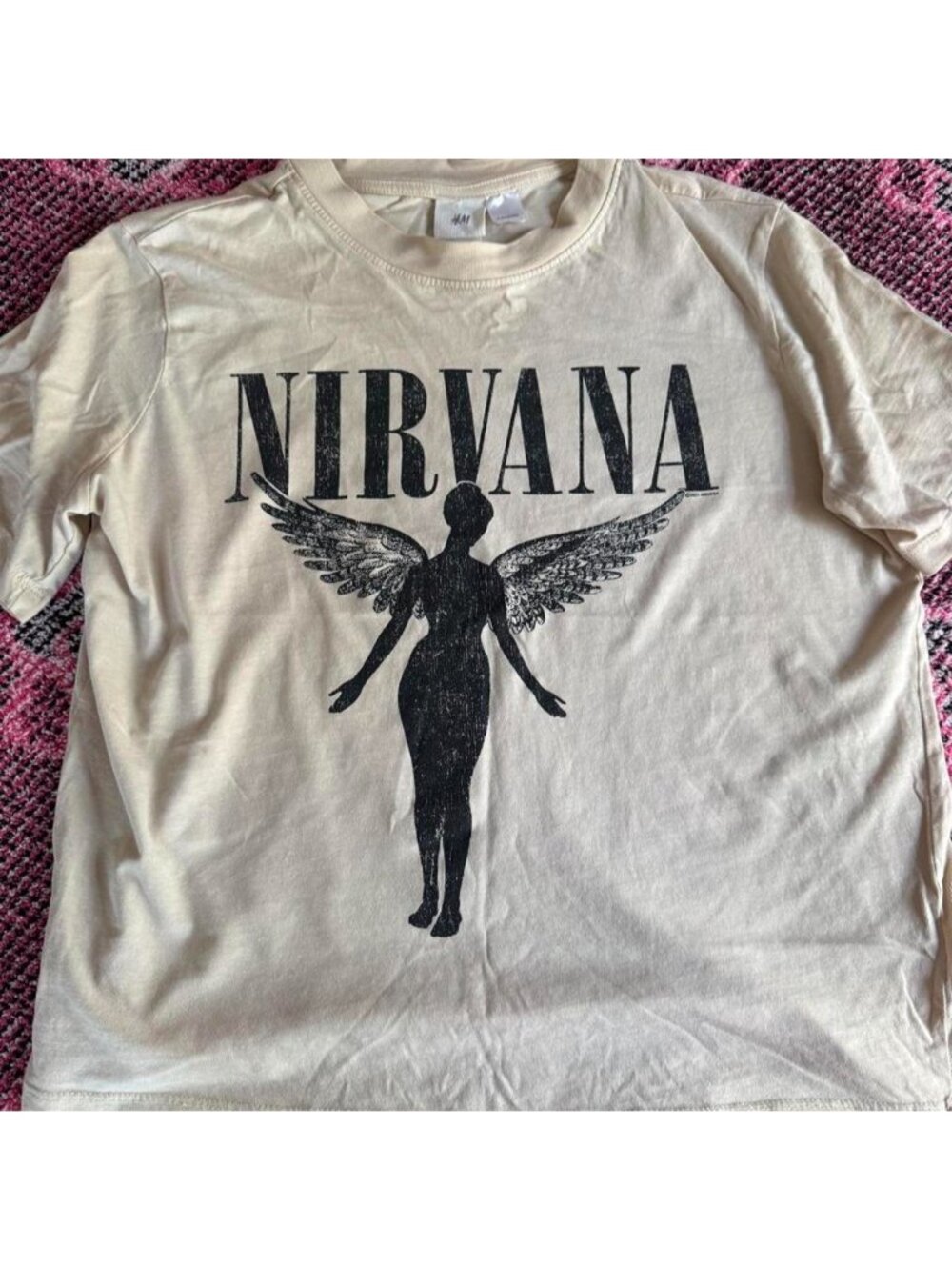 Nirvana H&M cream t-shirt with black graphic of a winged figure, size S